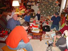 the family seated by the Christmas tree with gifts